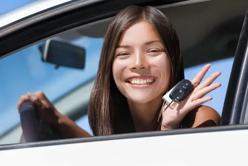 Woman proudly holding car keys